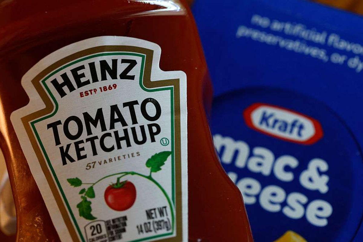 A bottle of Heinz tomato ketchup is displayed next to a box of Kraft Mac & Cheese