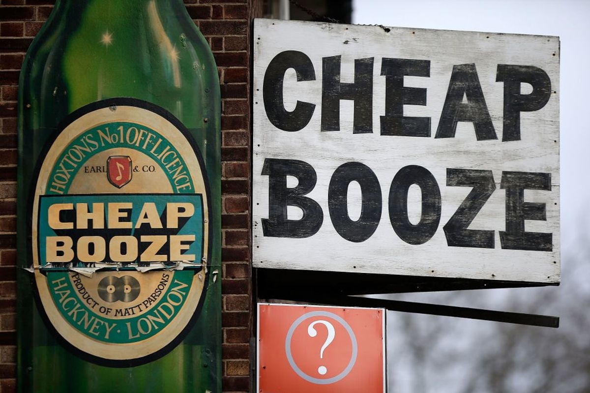  A "Cheap Booze" sign displayed outside a Hoxton off licence