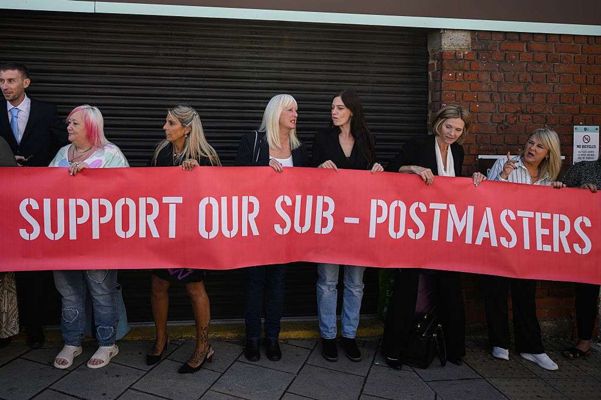 A group of those affected by the Horizon IT issue hold a banner
