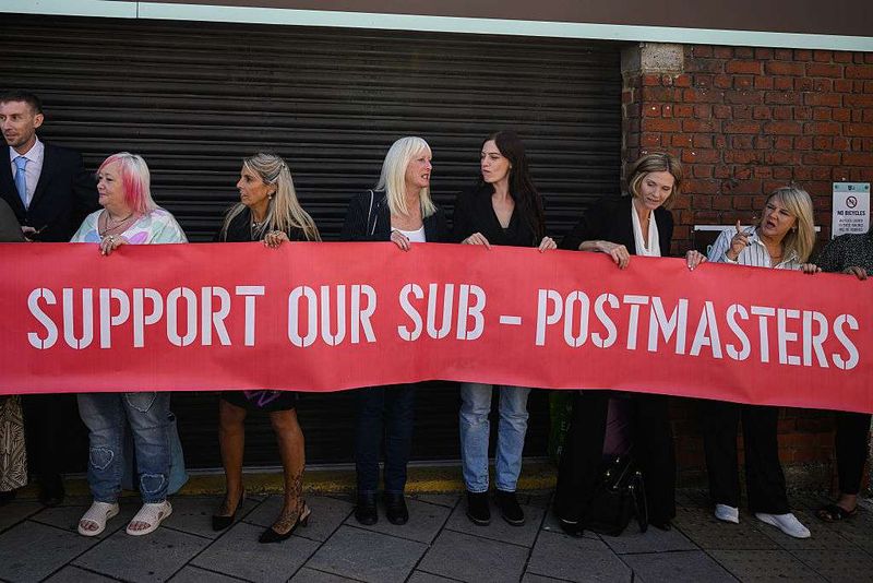  A group of those affected by the Horizon IT issue hold a banner