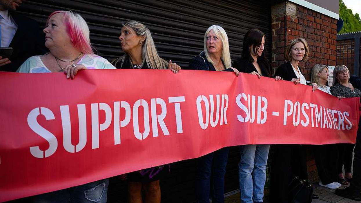 A group of those affected by the Horizon IT issue hold a banner