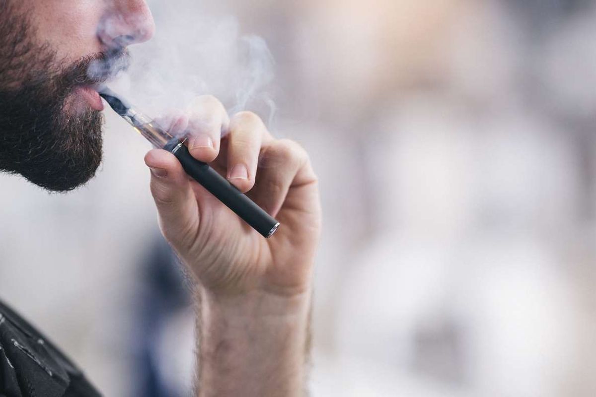 a man vaping e-cigarette