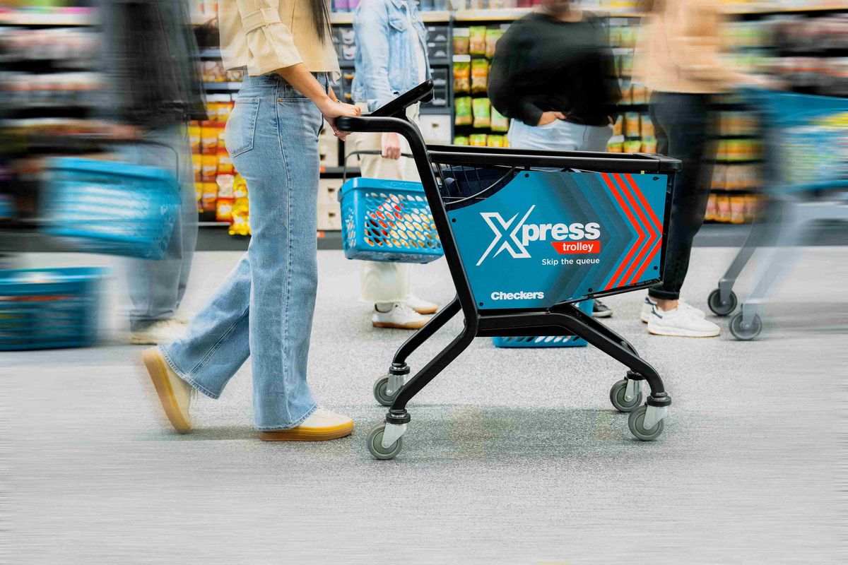 A model poses with a Checkers smart trolley