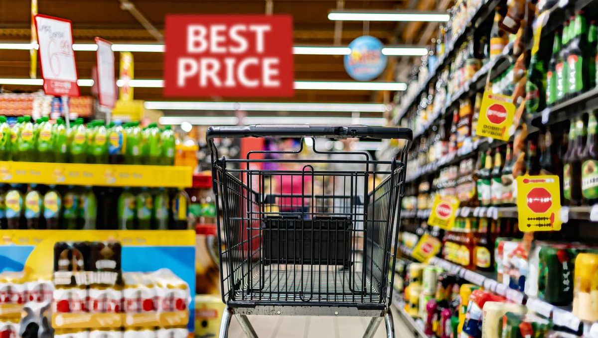 A shopping cart by a store shelf in a supermarket