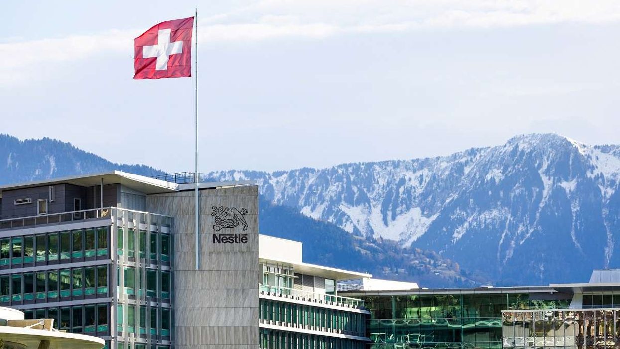 A Swiss flag flutters on the headquarters of Nestle in Vevey, Switzerland