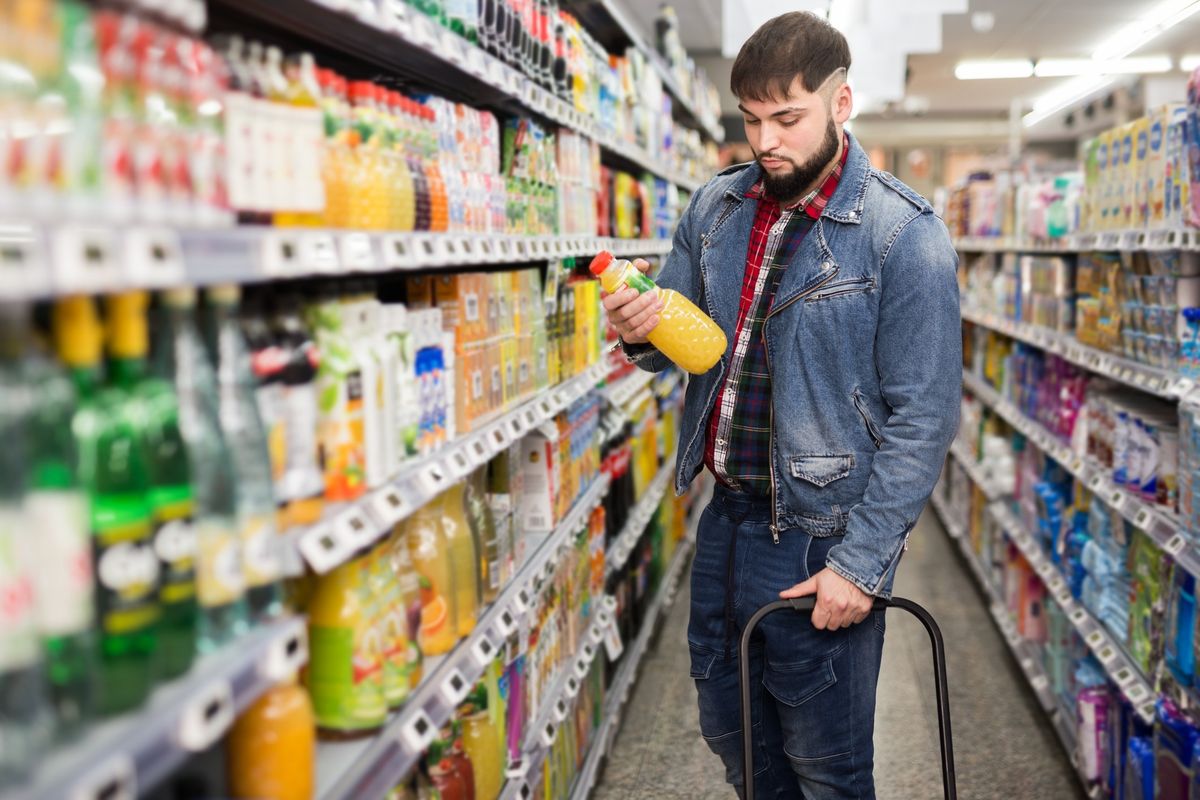 A UK supermarket shelf with price tags showing rising costs, reflecting the BRC’s March 2025 report on food inflation at 2.4% and ambient food at 3.7%.