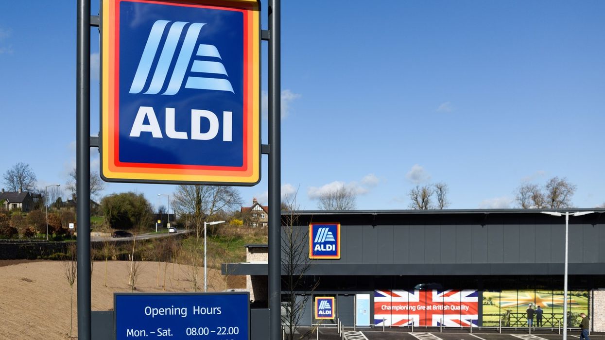Aldi supermarket exterior with store sign and opening hours displayed prominently