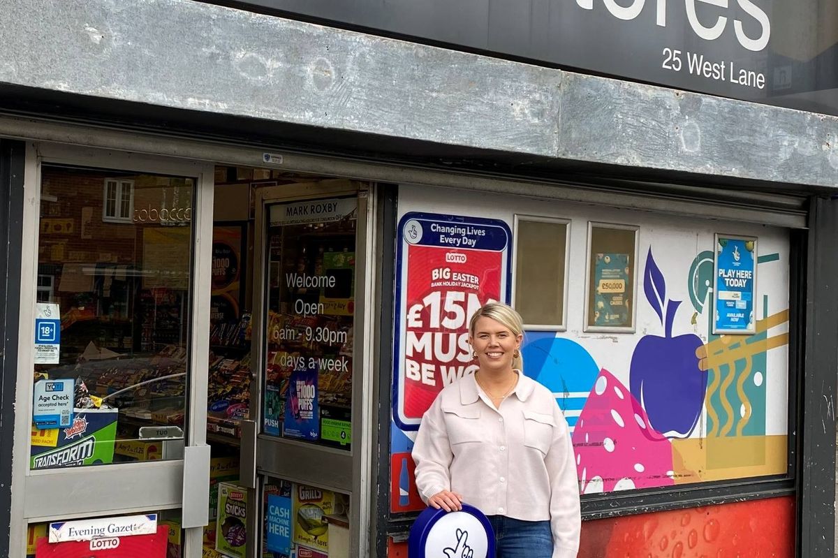 Amy Fowler of Arncliffe Stores holding Allwyn cheque for £10,000 lottery prize
