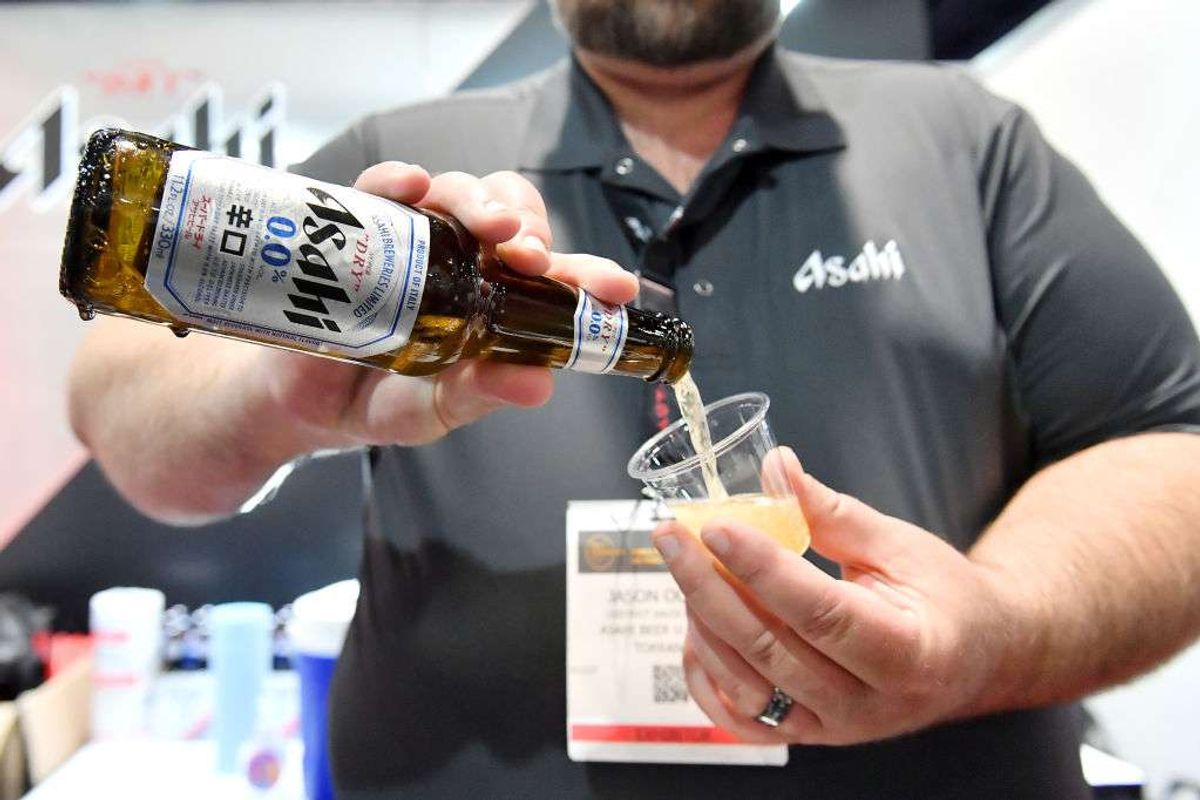 An Asahi representative pours a sample of nonalcoholic beer