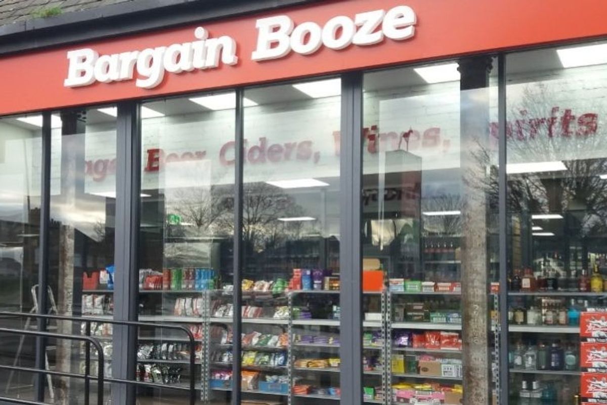 Bargain Booze Christmas ad featuring Santa Claus at store with naughty or nice tablet