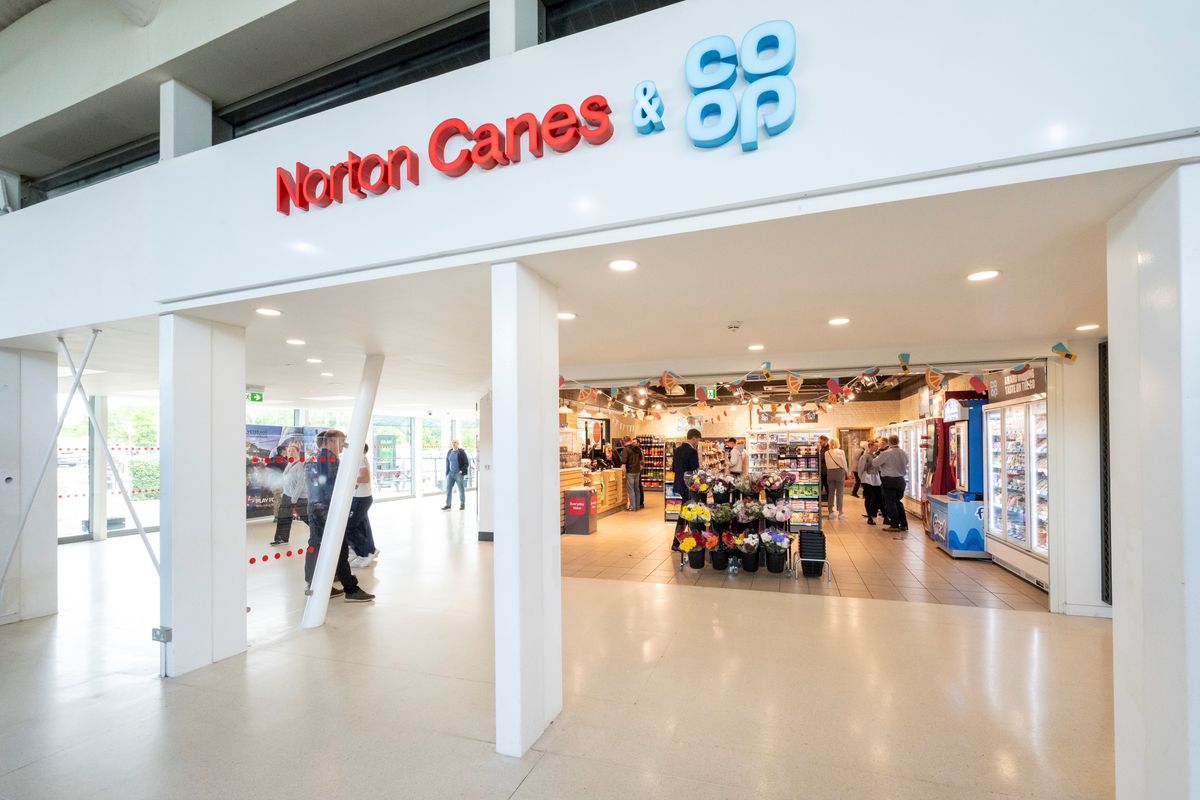 Co-op store at Norton Canes services with flower display and visible chilled food section.