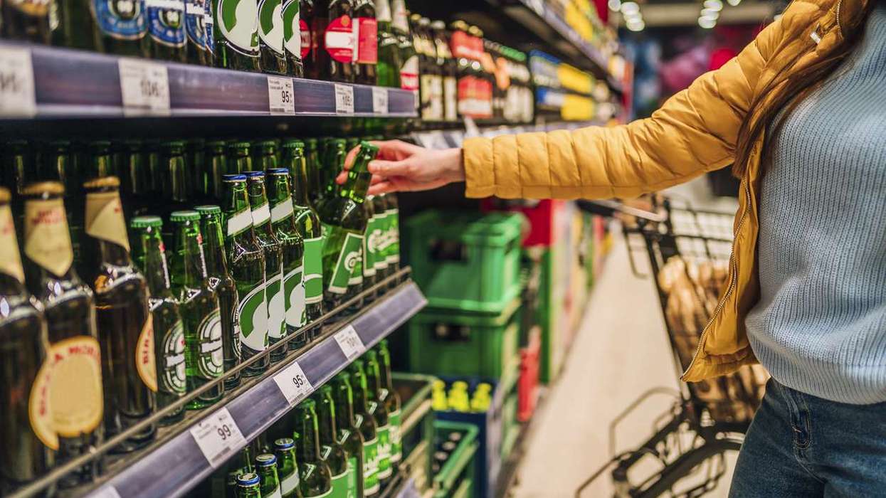 Customer buying beer in supermarket