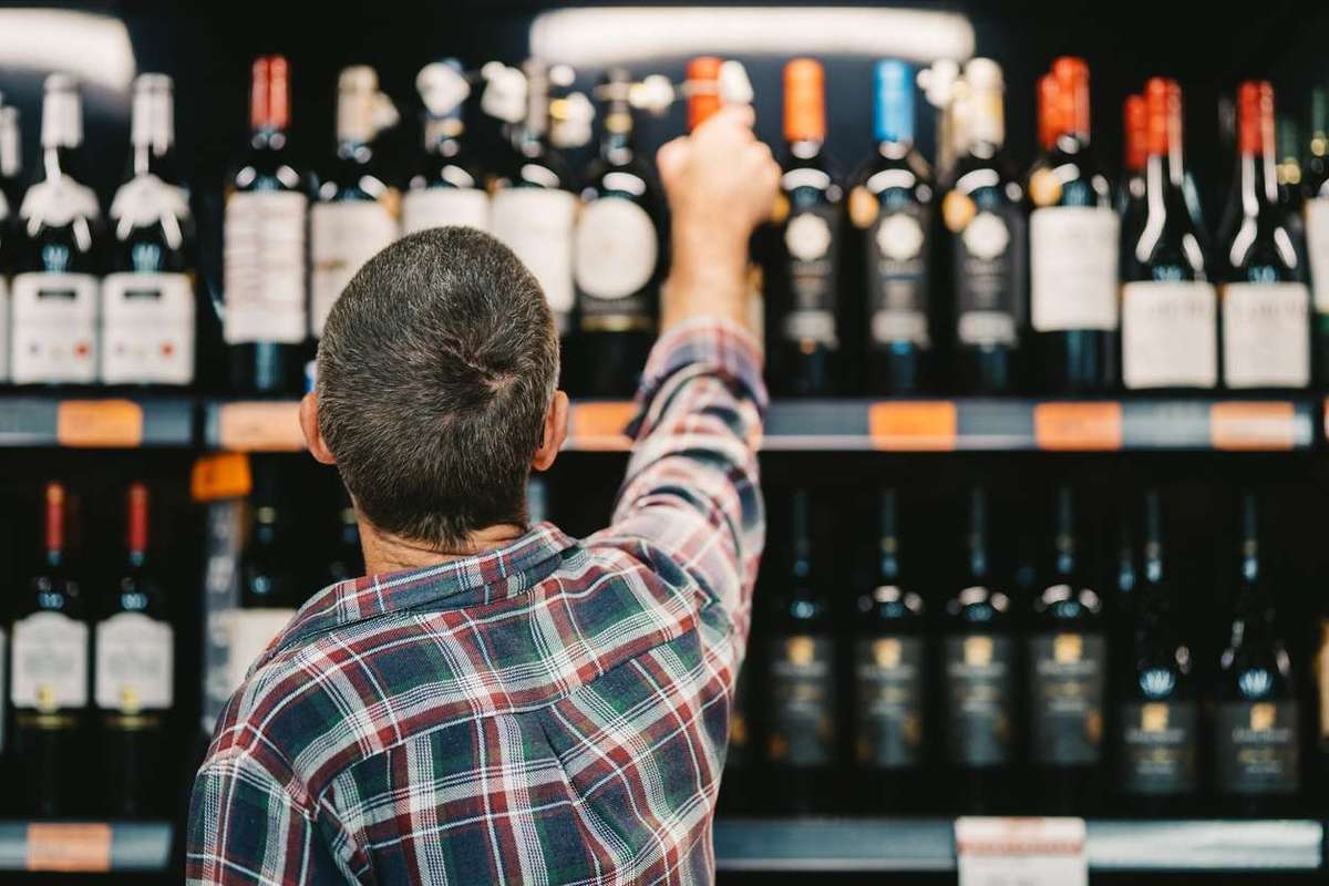 Customer picking a bottle of wine