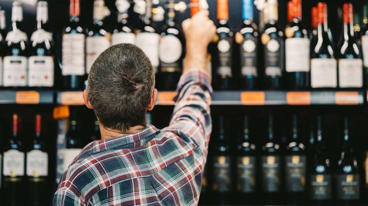 Customer picking a bottle of wine