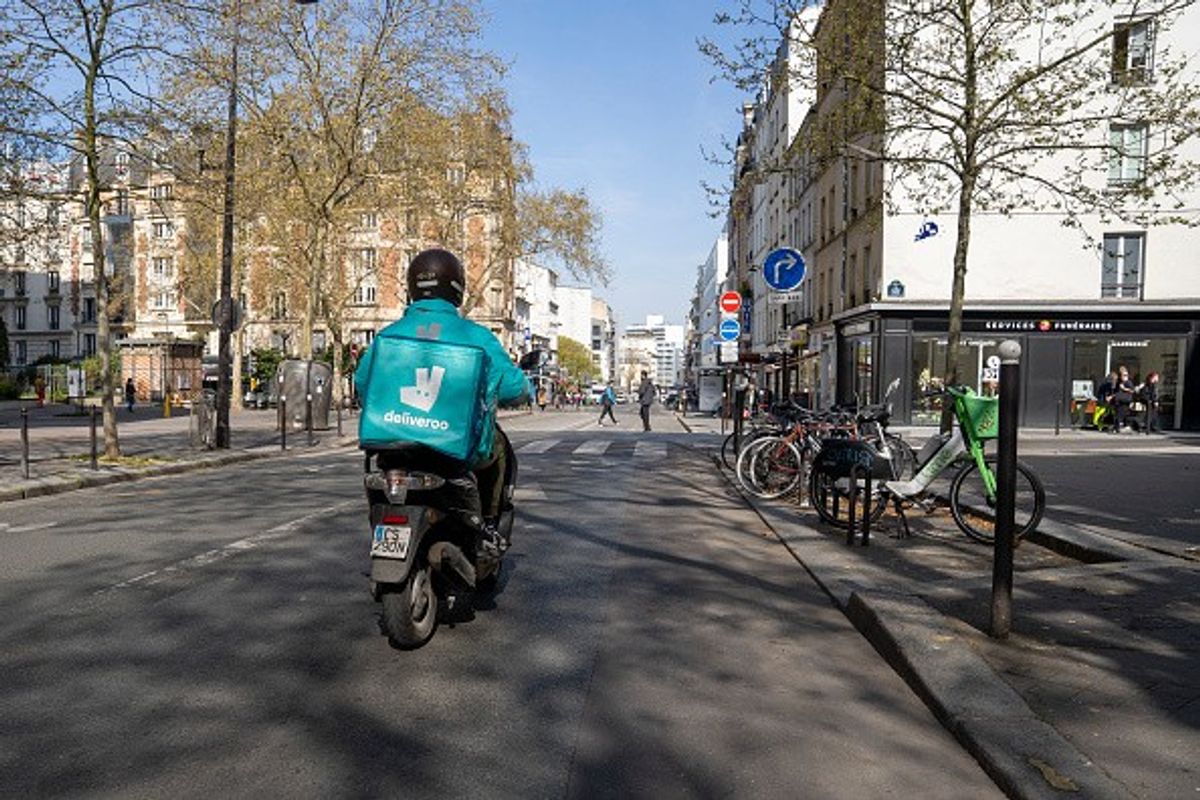 DoorDash and Deliveroo logos signifying £2.9 billion food delivery acquisition