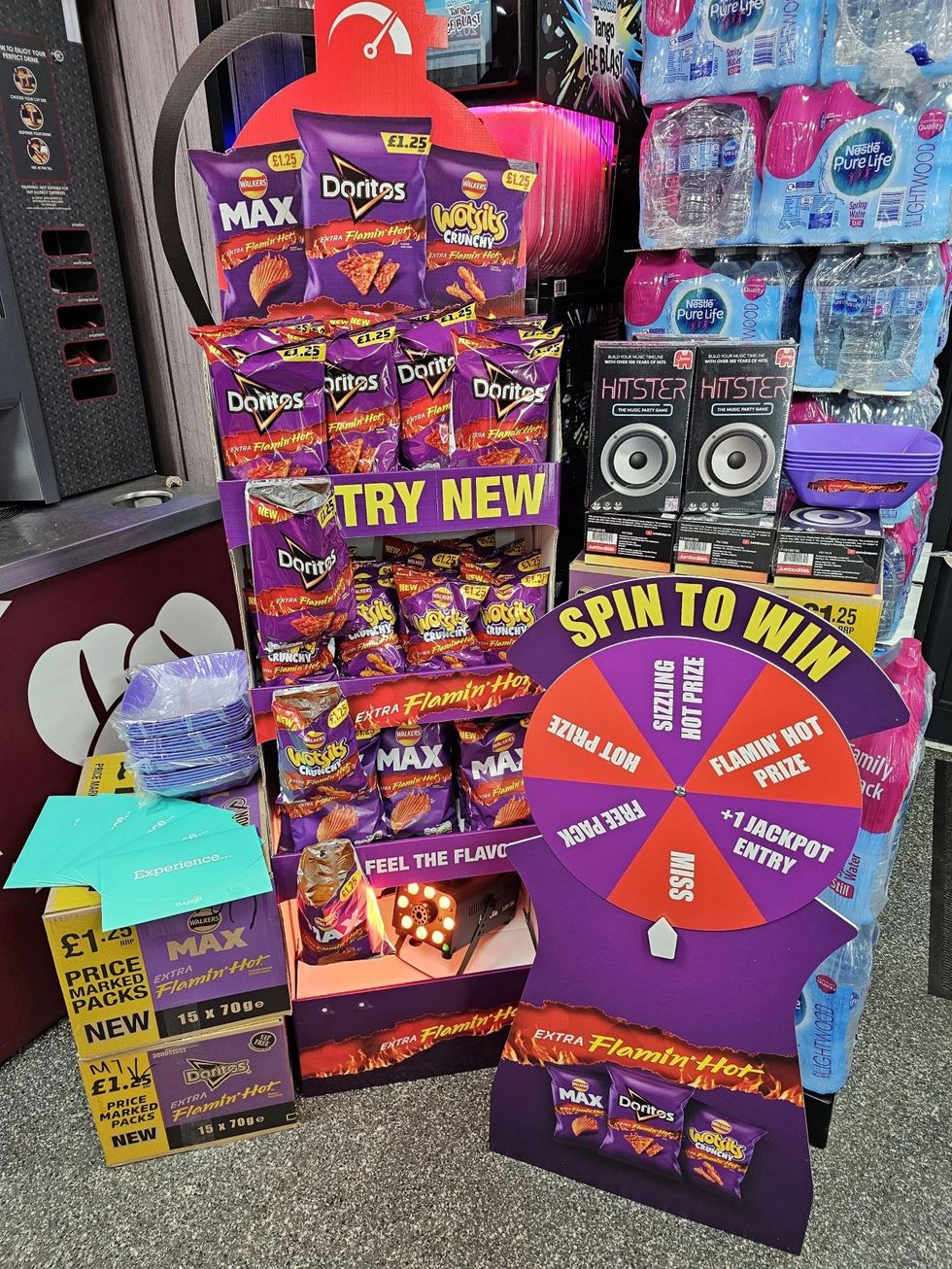 Doritos Dinamita in-store activation at BB Nevison Superstore with purple-themed POS and spin-to-win wheel