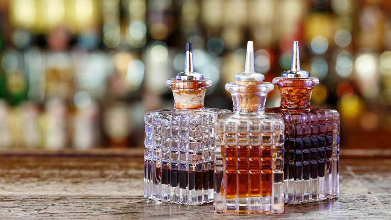 droppers for bitters and syrups stand in a row on a blurred background of the bar