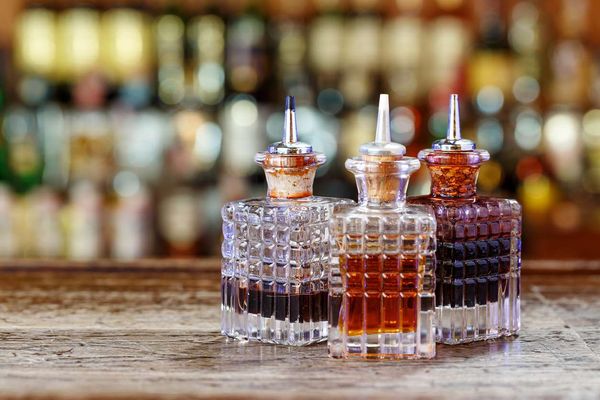 droppers for bitters and syrups stand in a row on a blurred background of the bar