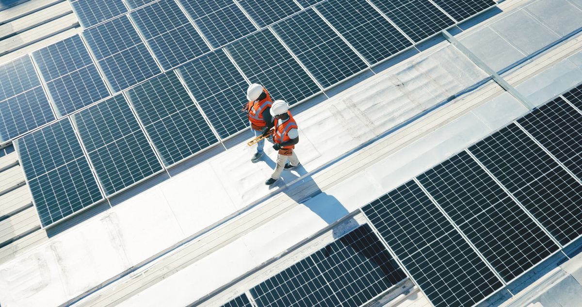 Engineers inspect rooftop solar panels 