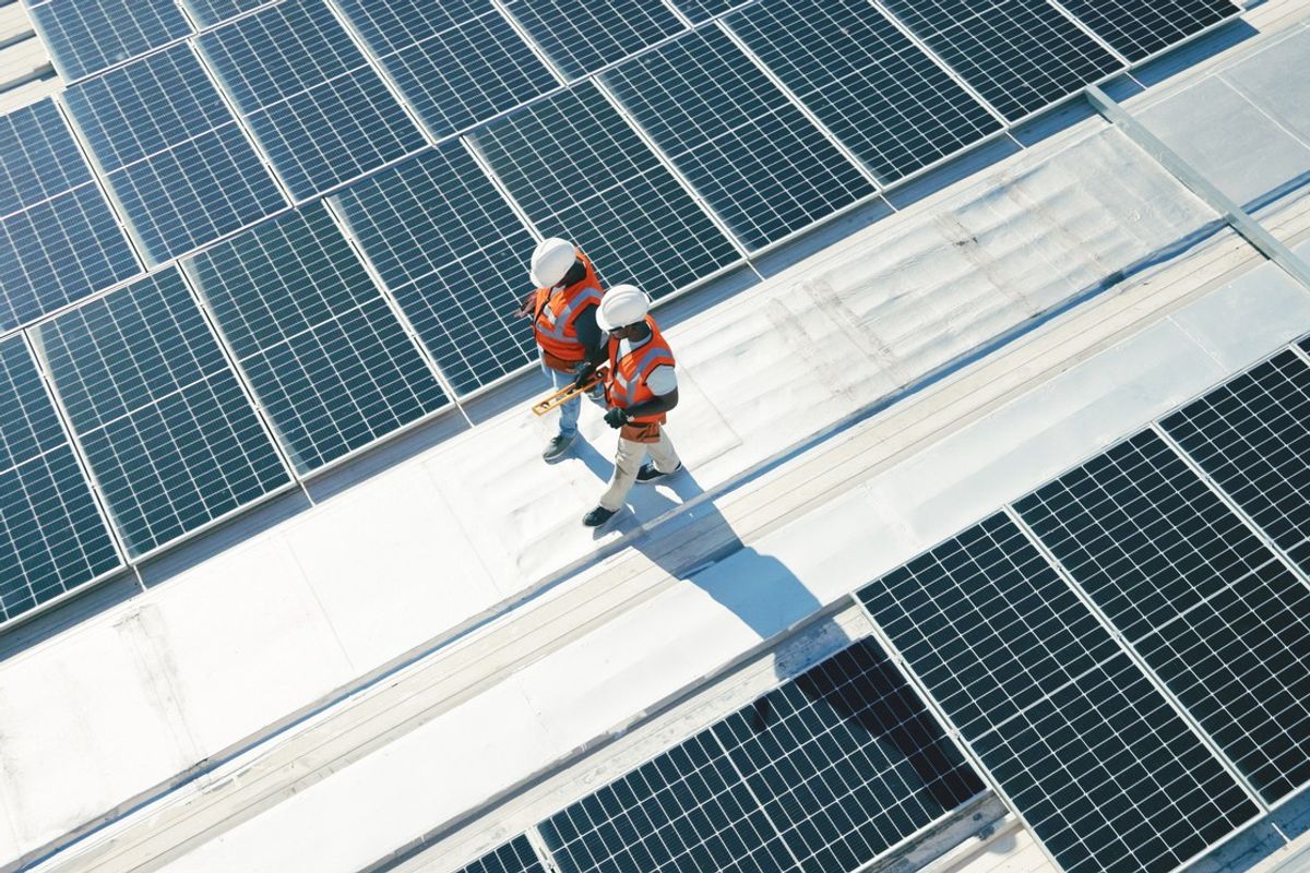 Engineers inspect rooftop solar panels