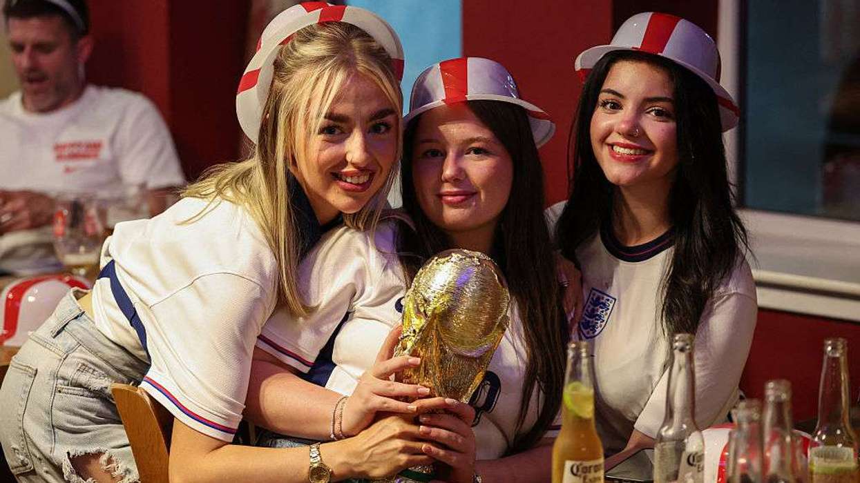 England supporters pose with a replica of FIFA trophy