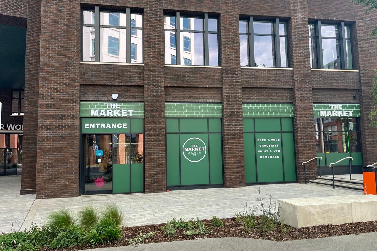Exterior view of The Market convenience store at Sugar House Island, Stratford, welcoming shoppers.