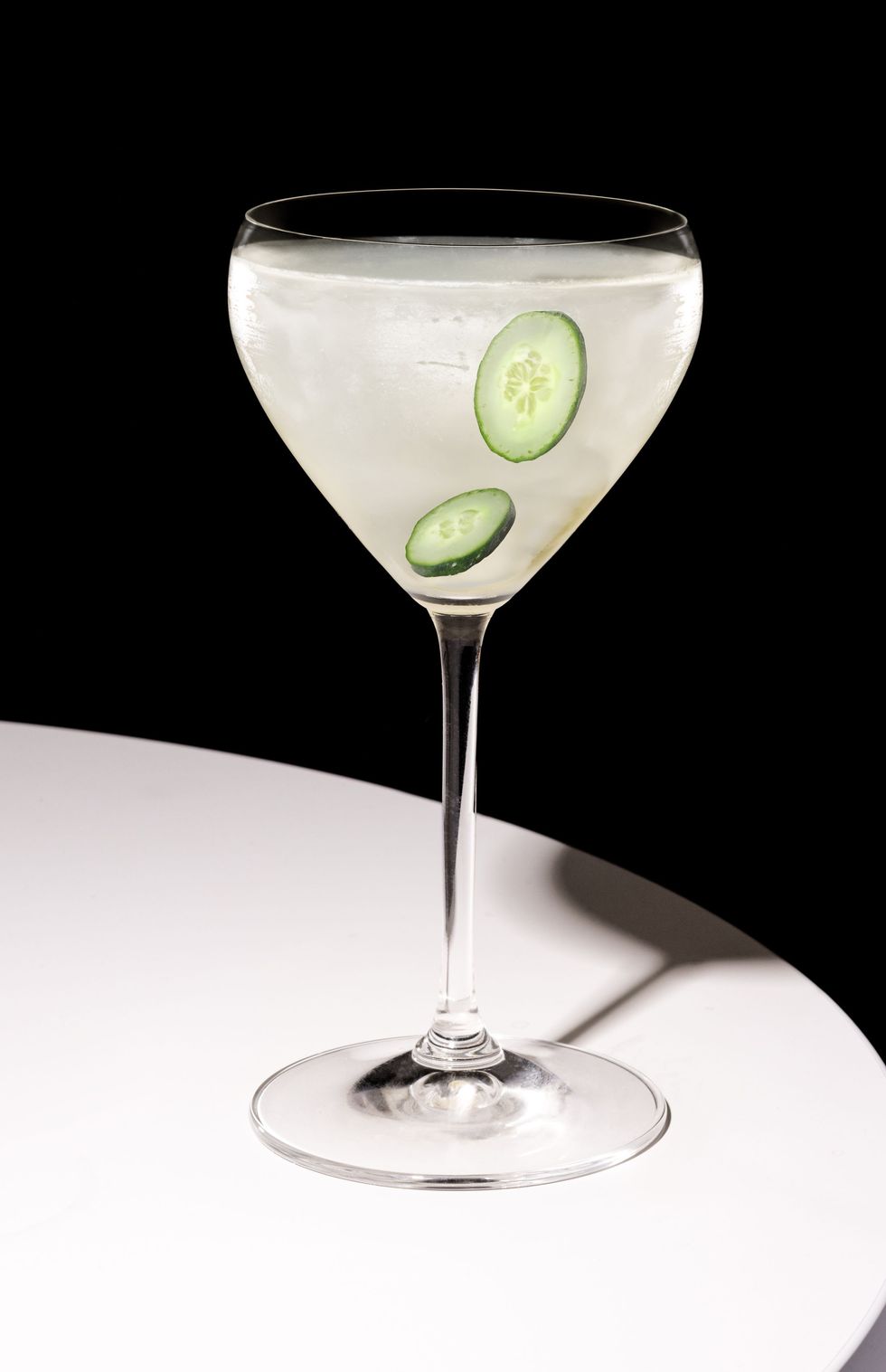 FAIR Cucumber Liqueur cocktail in a martini glass with cucumber slices