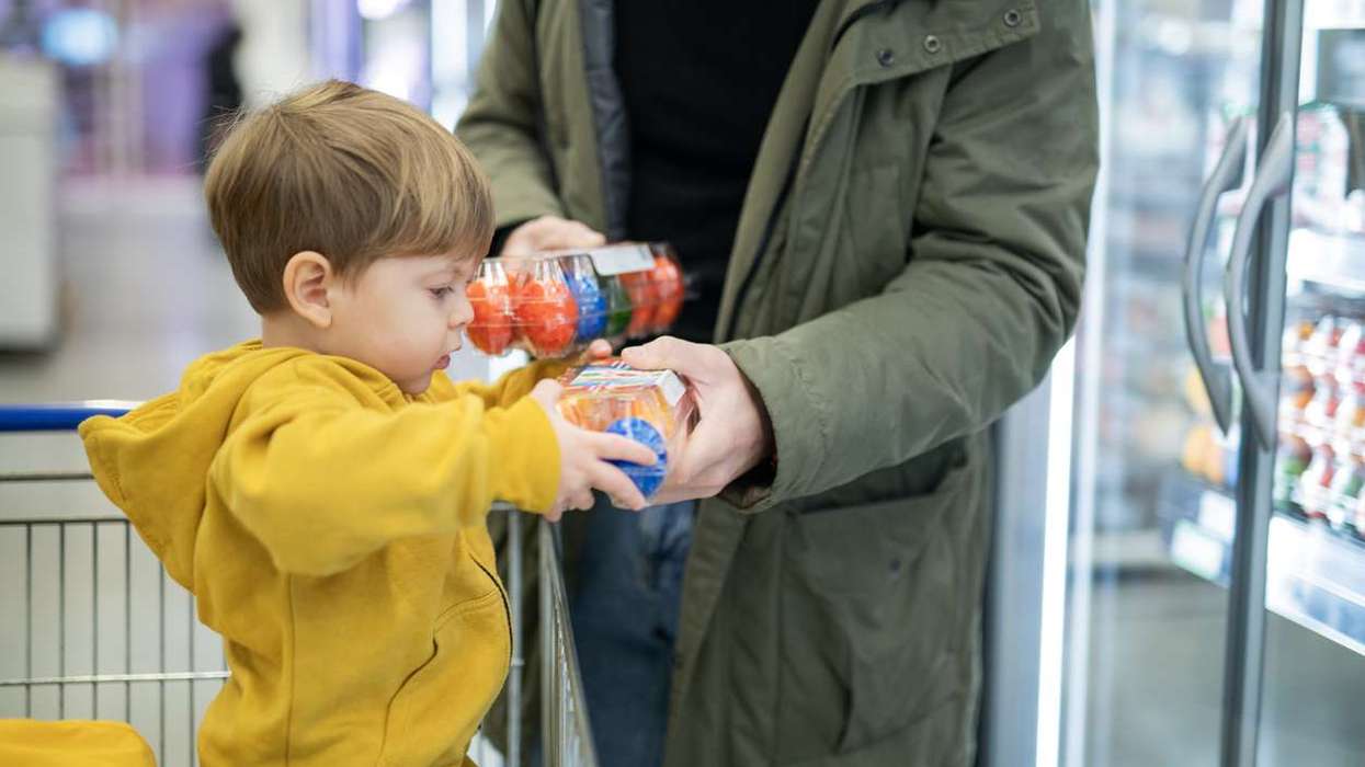 Father and son shopping Easter eggs in supermarket