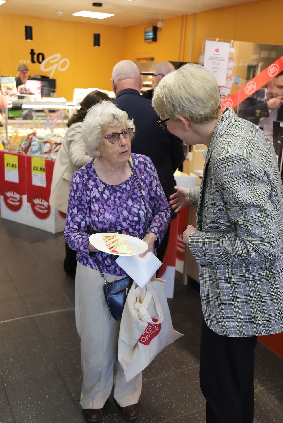 Fiona Drummond assisting customer at Post Office counter
