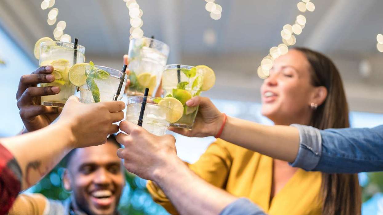 Gen Z friends drinking mojito cocktails