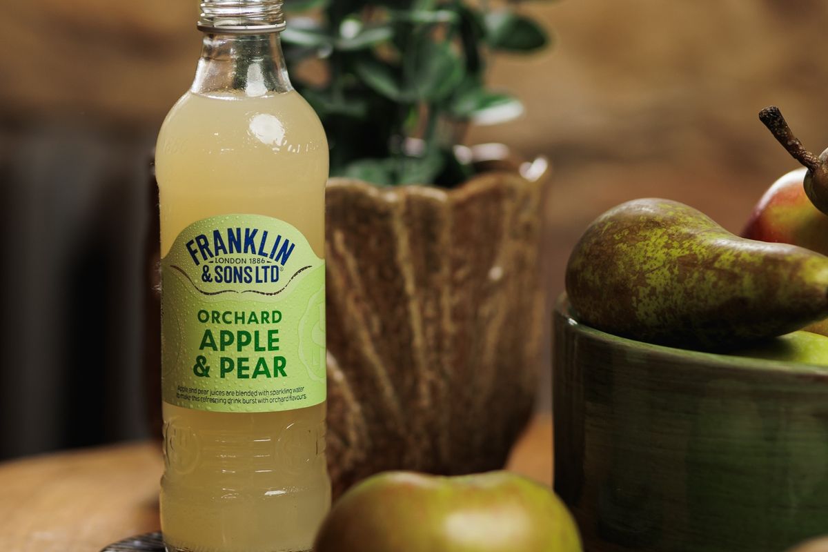 Glass filled with Apple and Pear Soft Drink with ice