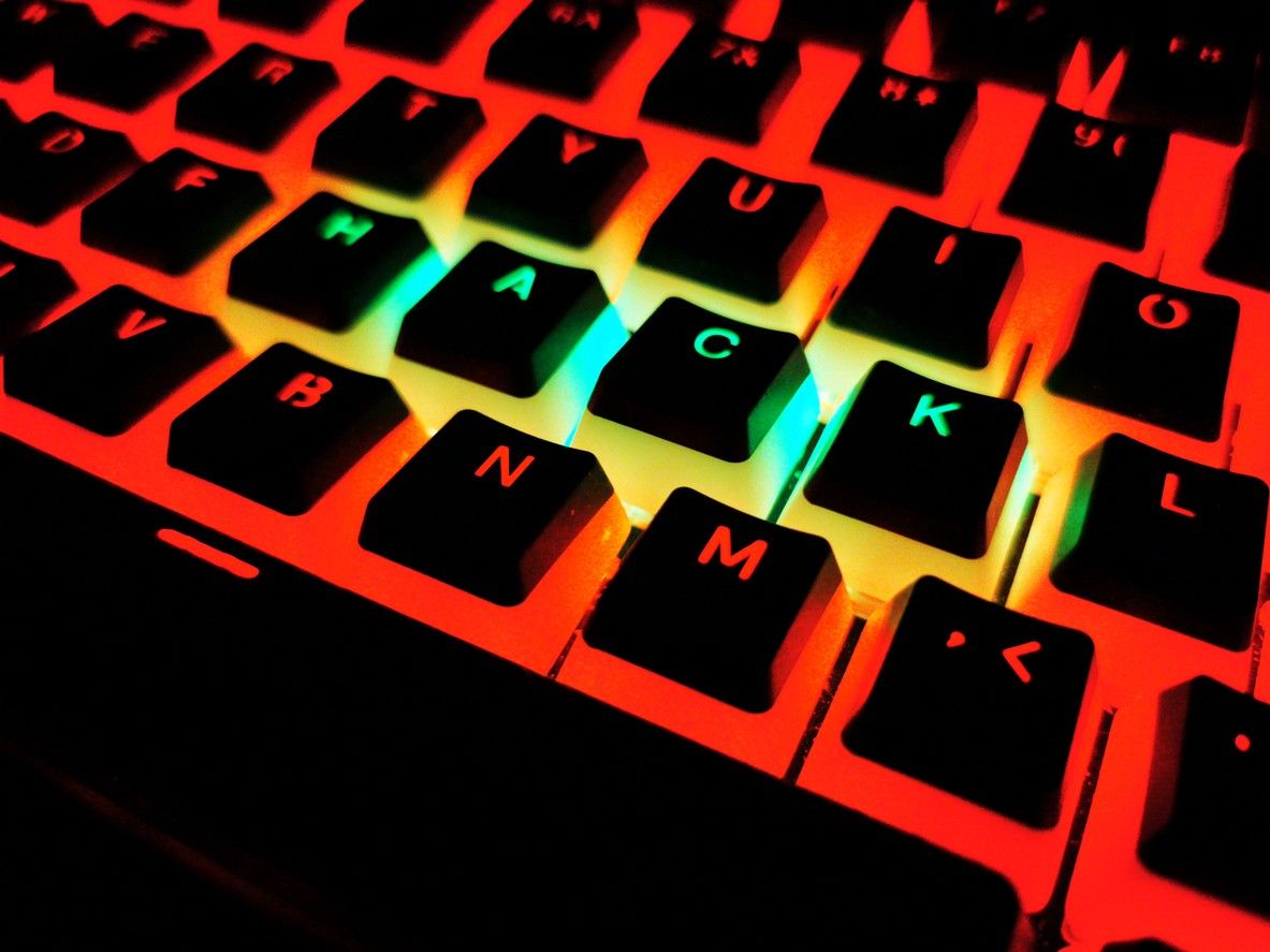 Glowing red keyboard with 'HACK' highlighted, symbolising cybercrime and digital threats.