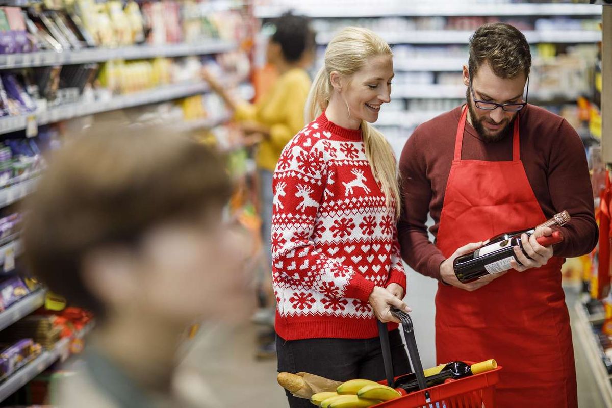 grocery store staff assists shopper during festive peak 