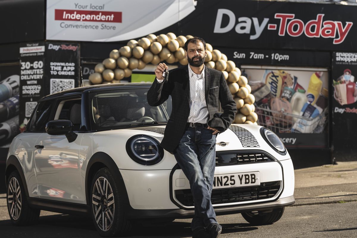 Imran Ghaffar of Wilsons Supermarket, Kirkcaldy, with his new Mini Cooper, won in JTI’s Mayfair Gold competition.