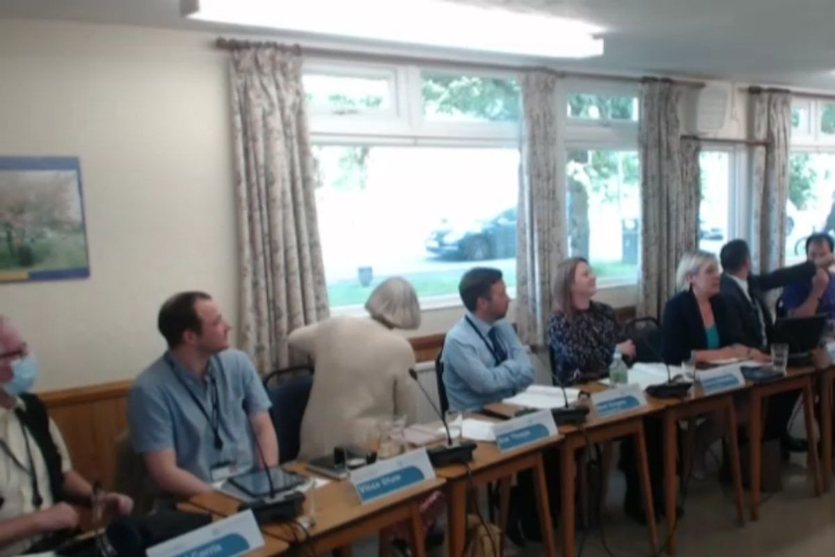 Moment cop abandons council meeting to chase suspected shoplifter