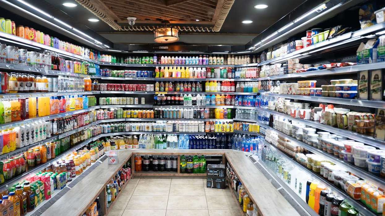 Interior of a modern convenience store with rows of refrigerated drinks