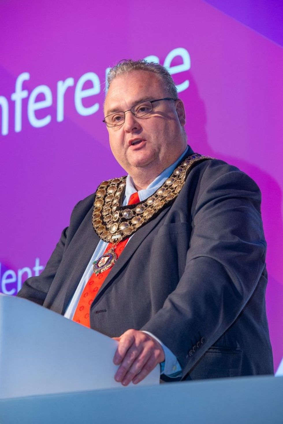 Jason addressing conference