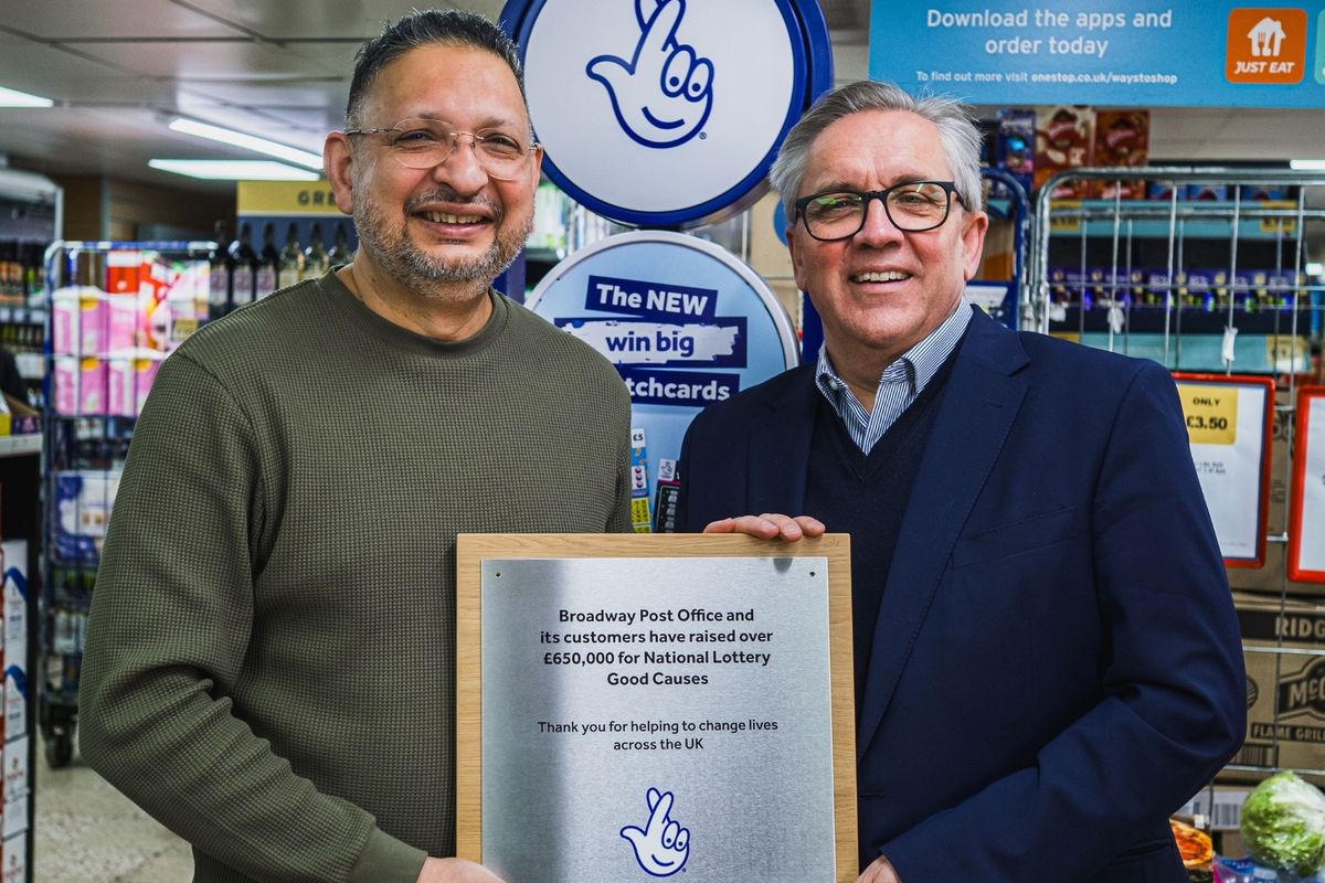 Justin King CBE presenting a National Lottery Good Causes award to Cardiff retailer Rashid Khalid at Broadway Post Office