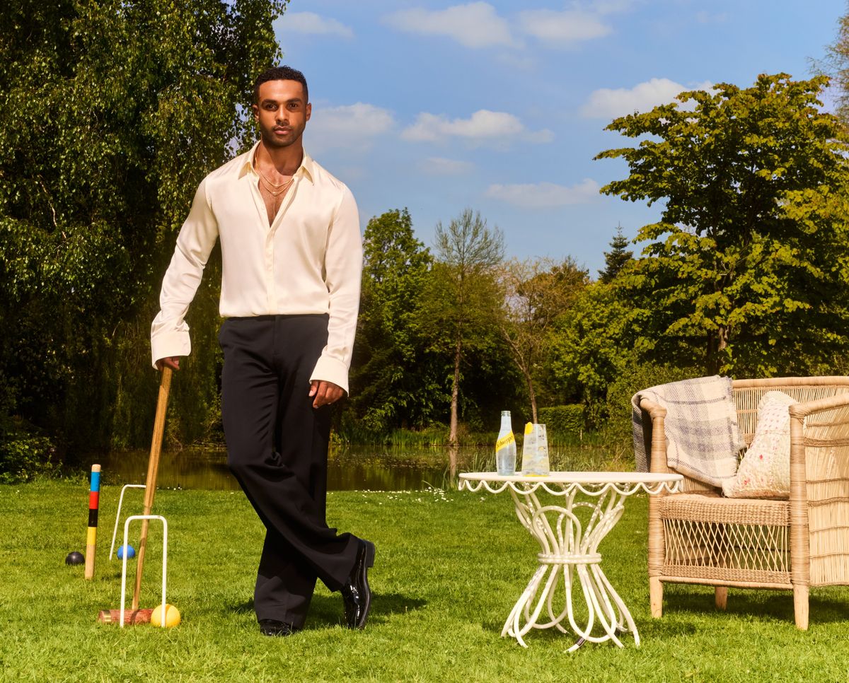 Lucien Laviscount holding Schweppes Tropical Soda at a summer party scene
