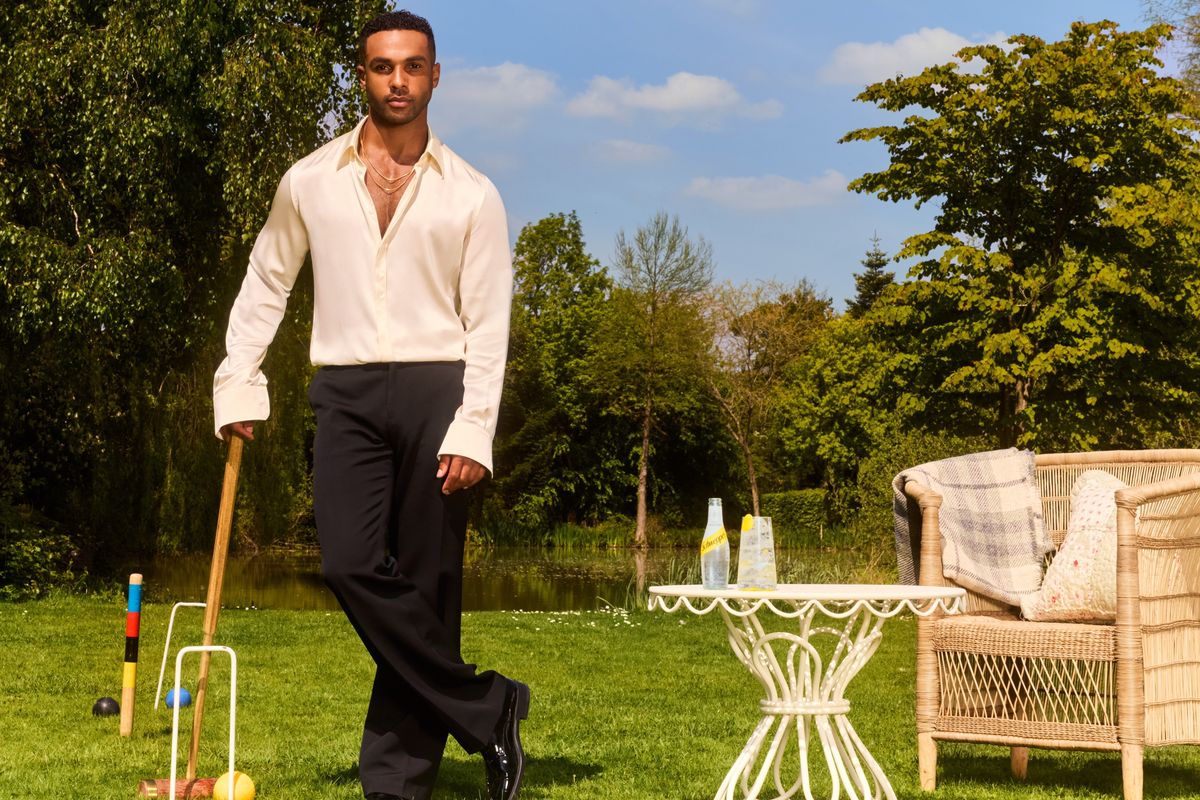 Lucien Laviscount holding Schweppes Tropical Soda at a summer party scene