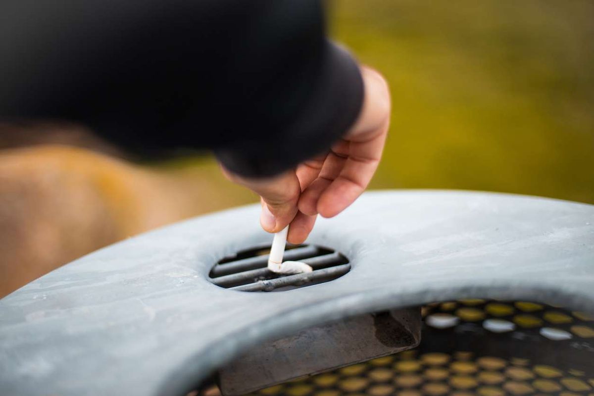 Man puts out a cigarette