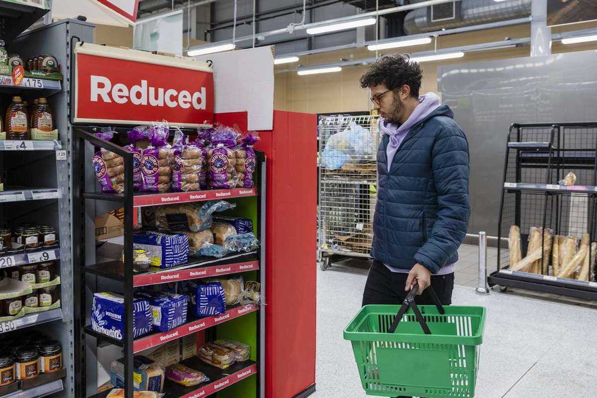 Man shopping in a supermarket browsing in the reduced section