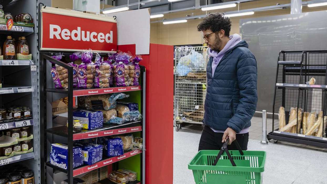 Man shopping in a supermarket browsing in the reduced section