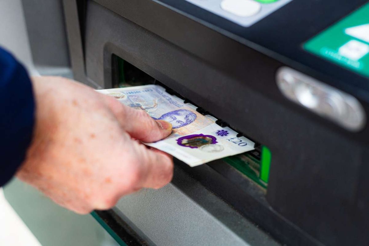 man withdrawing cash from ATM machine