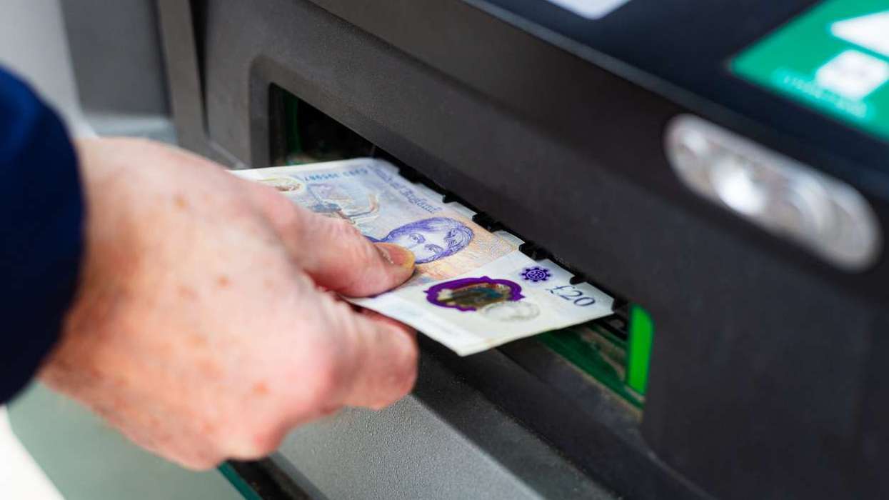 man withdrawing cash from ATM machine
