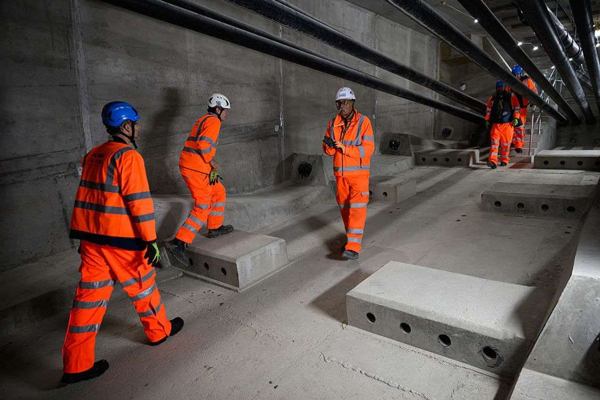 Members of the HS2 team walk on the internal walkway of the Colne Valley viaduct
