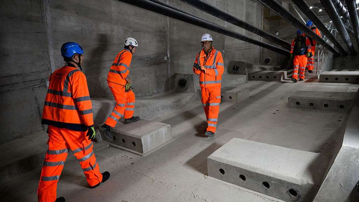 Members of the HS2 team walk on the internal walkway of the Colne Valley viaduct