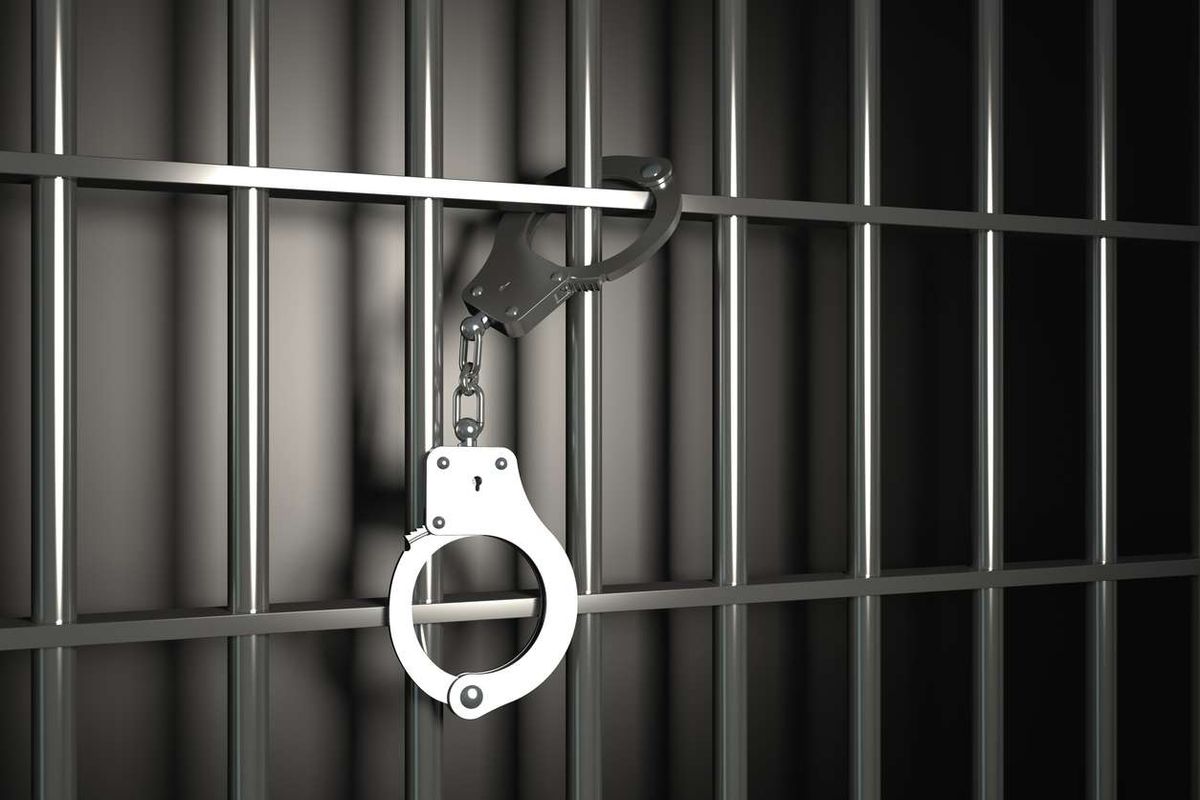 Metal prison bars with handcuffs 