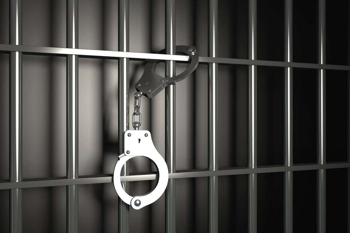 Metal prison bars with handcuffs