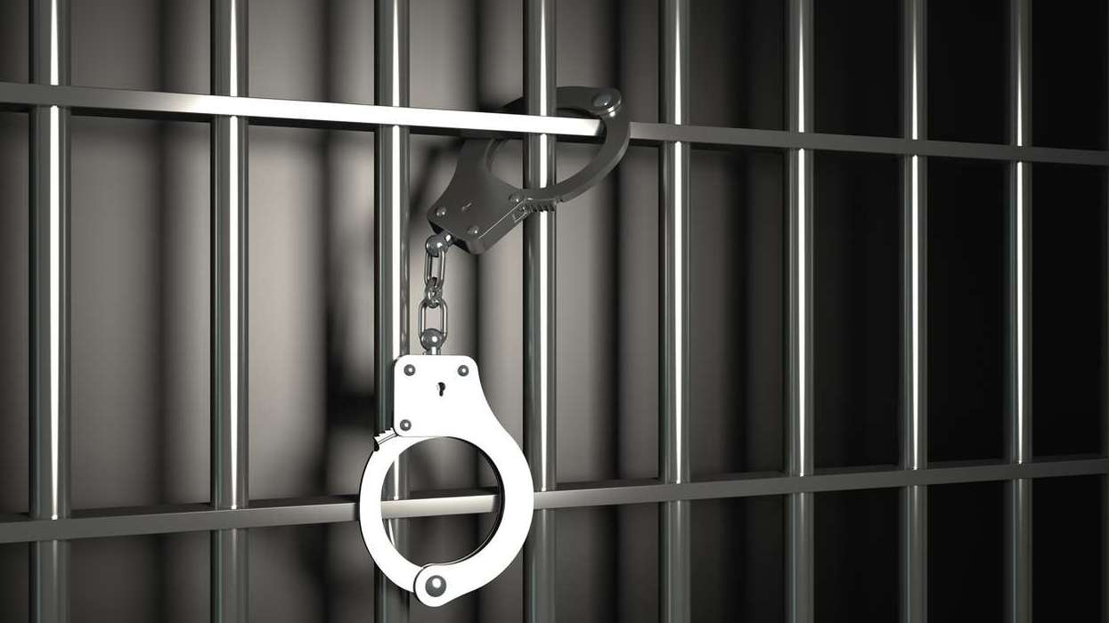 Metal prison bars with handcuffs